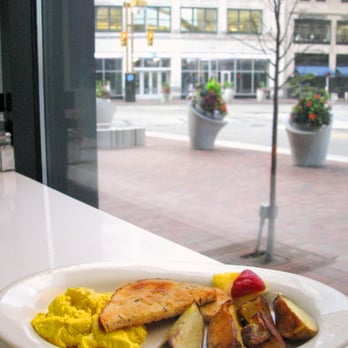 Grilled chicken breast plate with eggs and roasted potatoes by the window