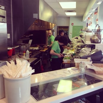 Kitchen staff preparing food behind the counter