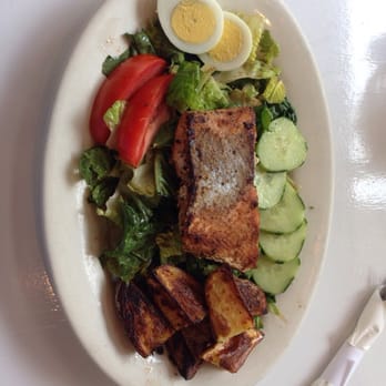 Grilled salmon over a garden salad with egg, tomato and cucumber