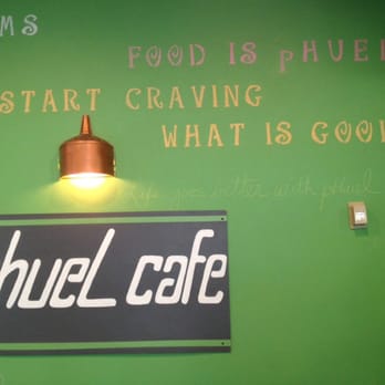 The pHuel Cafe wall sign and warm interior, painted in sage green with copper accents